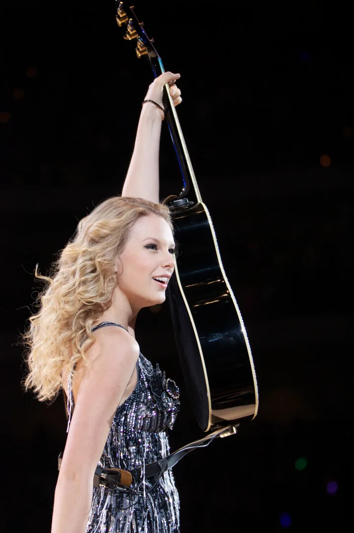 The guitar raised above the stage