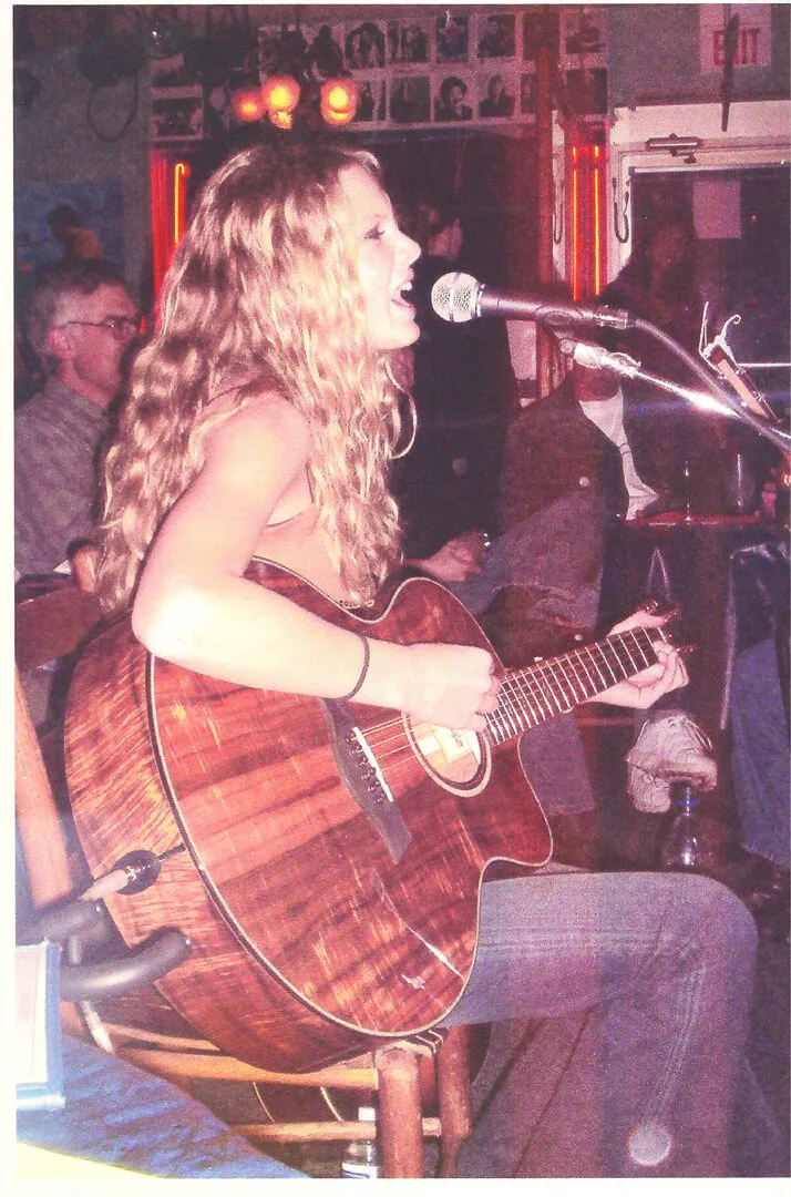An early performance with acoustic guitar