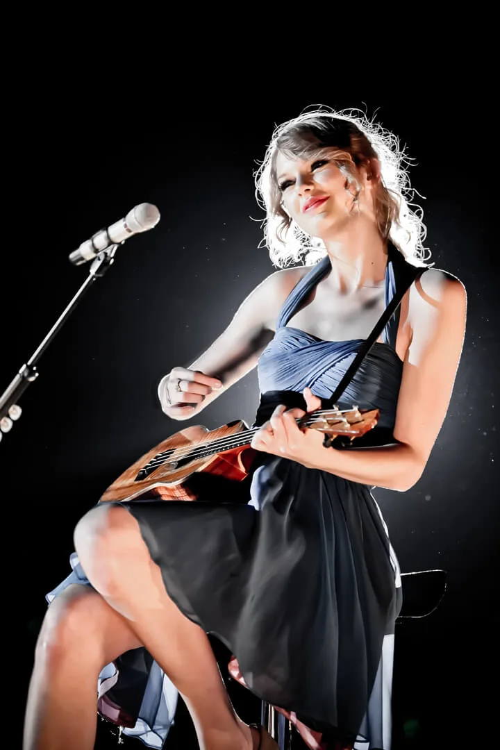 A seated acoustic performance in a dark dress