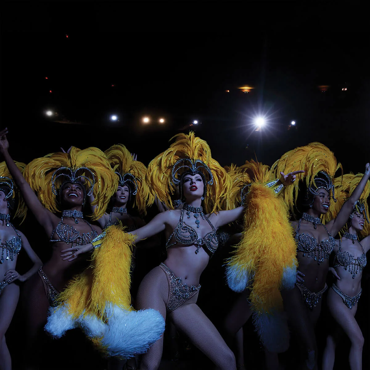 Feathers repeat across a group of performers