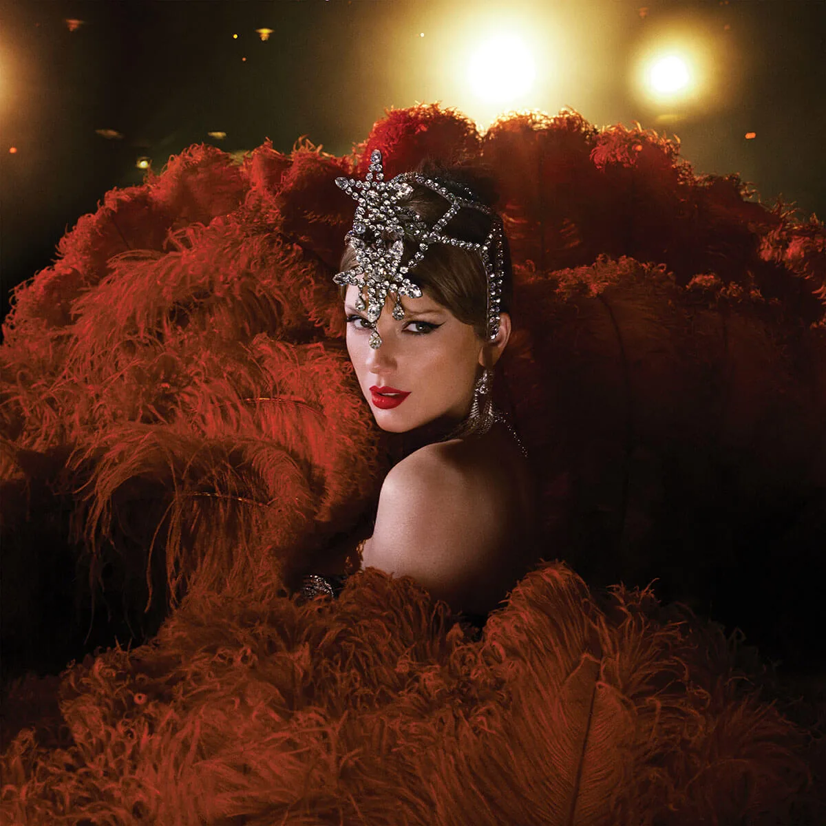 A close portrait framed by orange feathers