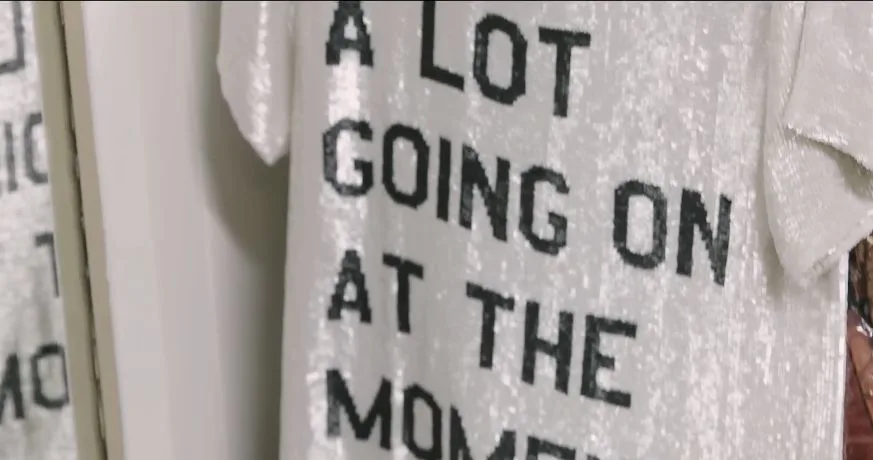Close-up of black lettering on the white sequined shirt associated with 22
