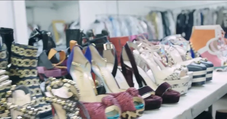 A table holding patterned platforms, metallic shoes and pointed pumps